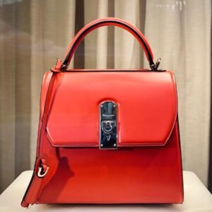 red leather handbag on white table